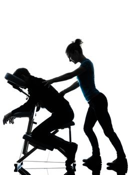 one man and woman performing chair back massage in silhouette studio on white background