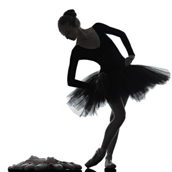 one caucasian young woman ballerina ballet dancer dancing with tutu in silhouette studio on white background