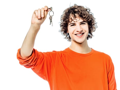 one young man caucasian holding keys portrait in studio white background