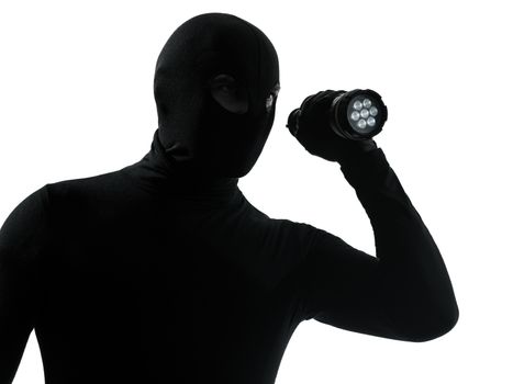 thief criminal with flashlight in silhouette studio isolated on white background