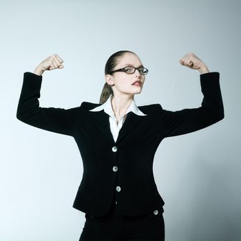 studio shot portrait of one caucasian young woman feeling strong
