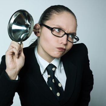 studio shot portrait of one caucasian curious business woman hearing aid funnel curious spying gossip