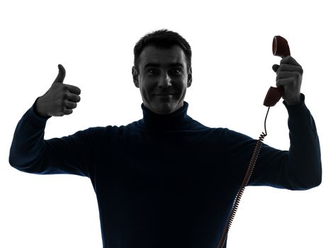 one caucasian man on the phone thumb up portrait in silhouette studio isolated on white background