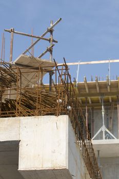 Detail of a building under construction with concrete, reinforcement and scaffold