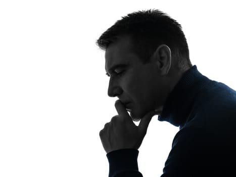 one caucasian man serious thinking pensive portrait in silhouette studio isolated on white background