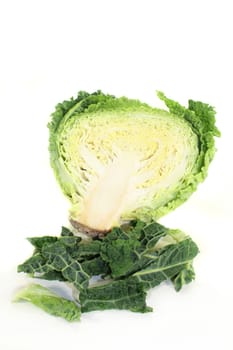 a sliced savoy cabbage against white background