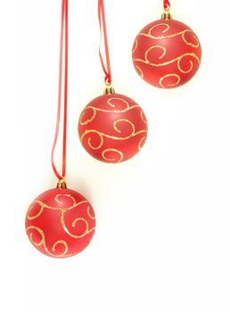 Three christmas baubles over a white background