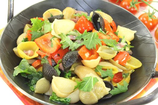 Pasta pan with bell pepper, tomatoes and garlic on a light background