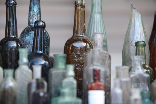 several old bottle on the table close to
