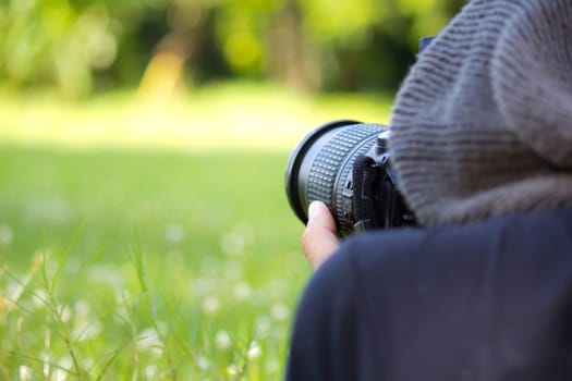 Man using a professional camera  in  the  field