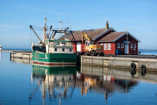 Fishing trawler docking in a Danish commercial harbor