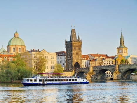 Charles Bridge of Prague with a boat on river Vltava