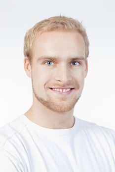 portrait of a young man with blond hair smiling