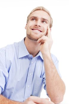 young man at office, sitting, daydreaming, smiling