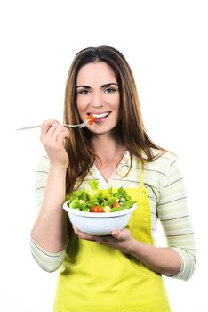 Young Woman Cooking and eating healthy Food - Vegetable Salad. Diet. Dieting Concept. Healthy Lifestyle. Cooking At Home. Prepare Food 