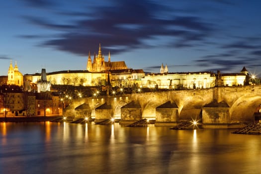 czech republic, prague - charles bridge and hradcany castle at dusk
