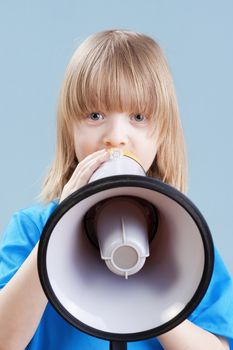 boy with long blond hair playing with megaphone - isolated on blue