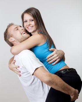 portrait of a happy young couple smiling, looking - isolated on gray