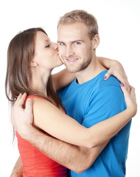 happy young couple - girl kissing boy, embracing - isolated on white
