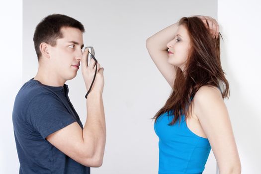 young man taking pictures of his girlfriend