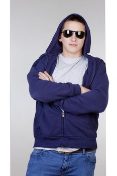 portrait of a young man with sunglasses and hood