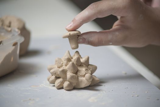 Girl make toyfrom clay. High resolution image.