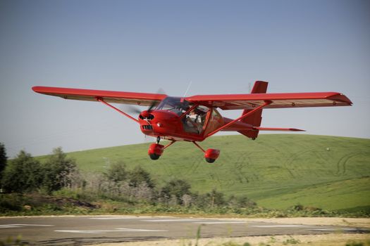 Red plane manned by student and teacher of a class flight practice, Jaen, Andalusia, Spain