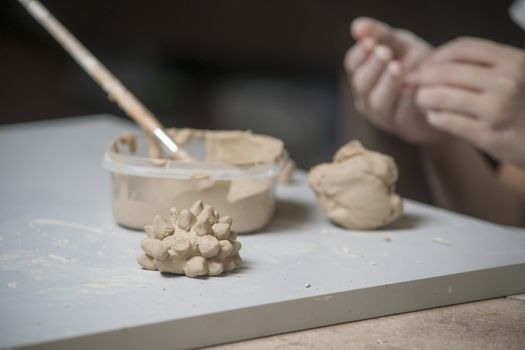 Girl make toyfrom clay. High resolution image.