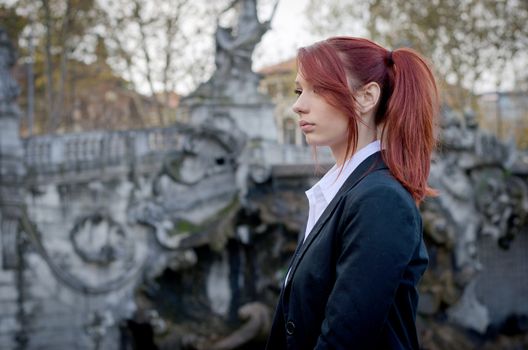 Elegant red-headed young man's profile outdoors, wearing jacket