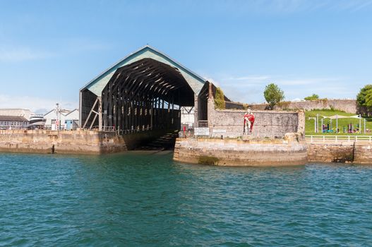 Harbor hangar with statue in Plymouth, Great Britain