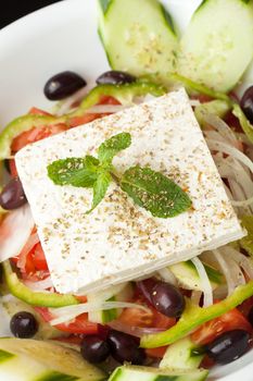 Mediterranean style or Greek garden salad with fresh goat cheese.