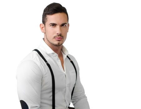 Elegant young man with white shirt and suspenders, isolated on white backgroung