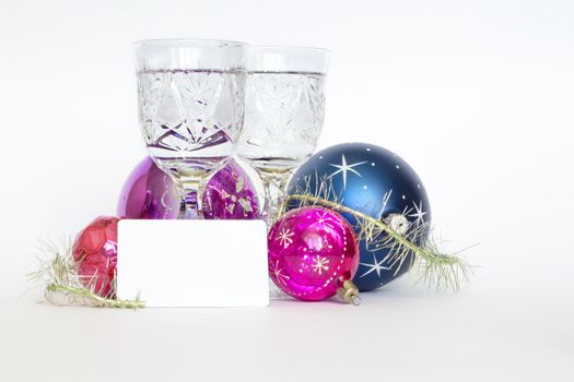 Arrangement of Christmas tree decorations and white card. white background