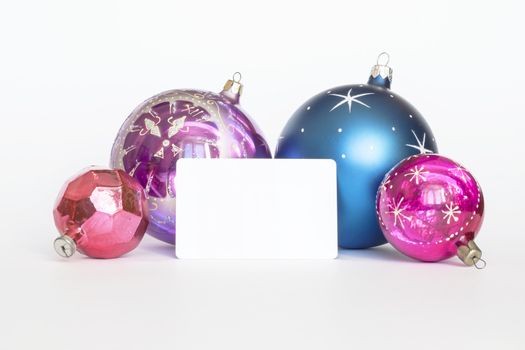 Arrangement of Christmas tree decorations and white card. white background