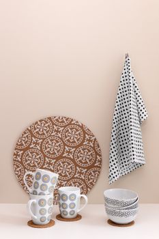 Stylish kitchen utensils. Cups, bowl, kitchen towel.