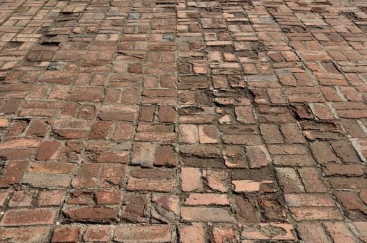 Fragment of old brick pavement surface in ancient monastery