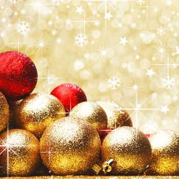 Golden and red Christmas balls on shiny background