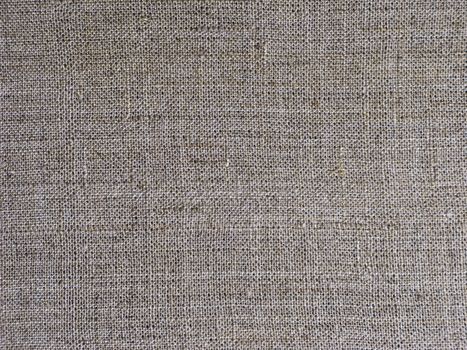 Fragment of gray rough flax fabric texture