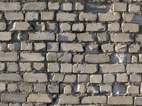 Fragment of old grey brick wall surface