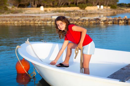 Kid girl pretending to be a sailor in boat bow at Formentera Balearic Islands