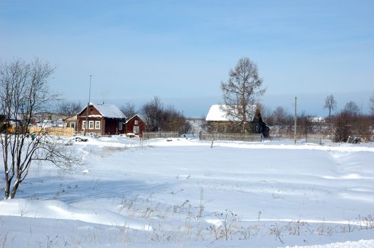 View of snowy russian village at winter sunny day