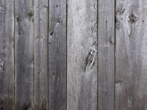 Fragment of old gray wooden surface background