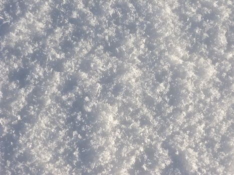 Texture of crystal snow surface on sunlight