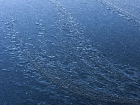 New blue ice surface background on frozen pond