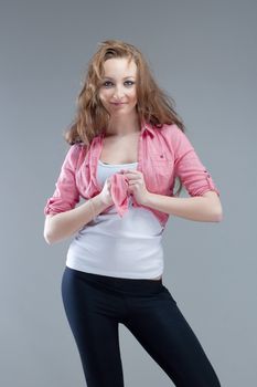 portrait of a young beautiful woman with brown hair smiling - isolated on gray