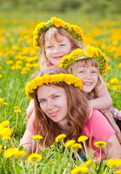 Young woman with two cute little girls enjoying a summer day outdoors