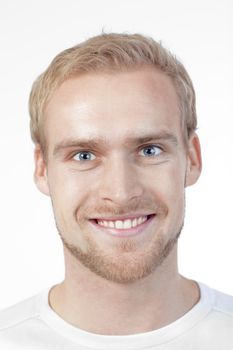 portrait of a young man with blond hair smiling - isolated on white