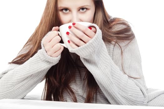 young woman with brown hair drinking cup of coffee