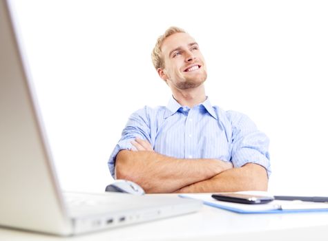 young man at office, sitting leaning back daydreaming, smiling