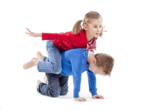 brother and sister having fun with each other - isolated on white